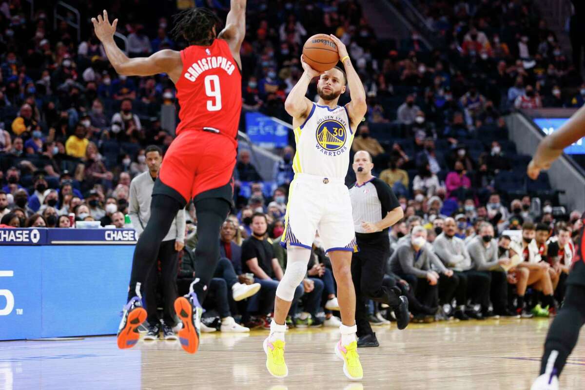 Golden State Warriors guard Stephen Curry (30) scores a three-point shot against Houston Rockets guard Josh Christopher (9) in the second quarter of an NBA game at Chase Center, Friday, Jan. 21, 2022, in San Francisco, Calif.