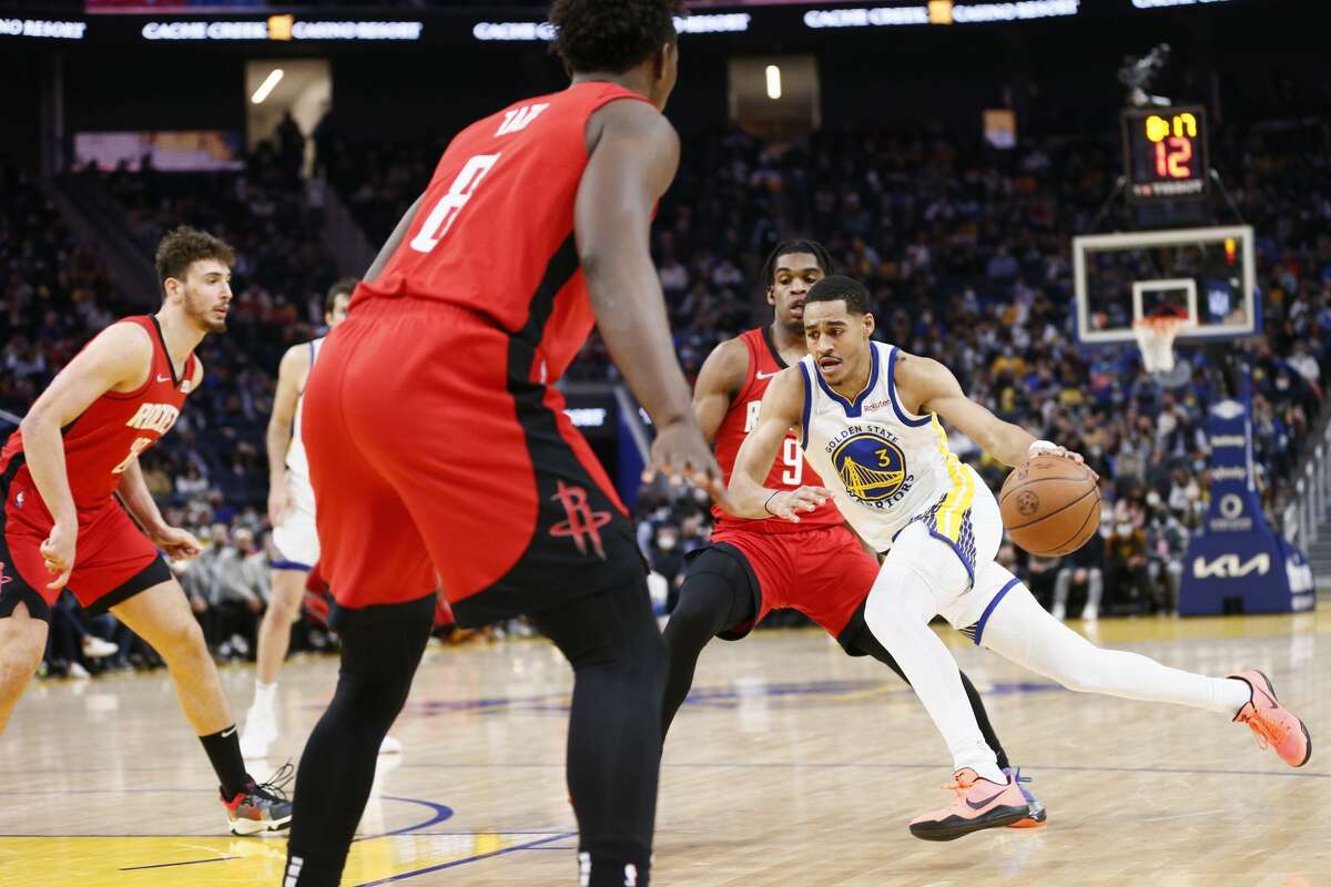 Golden State Warriors guard Jordan Poole (3) drives to the hoop against Houston Rockets guard Josh Christopher (9) in the second quarter of an NBA game at Chase Center, Friday, Jan. 21, 2022, in San Francisco, Calif.