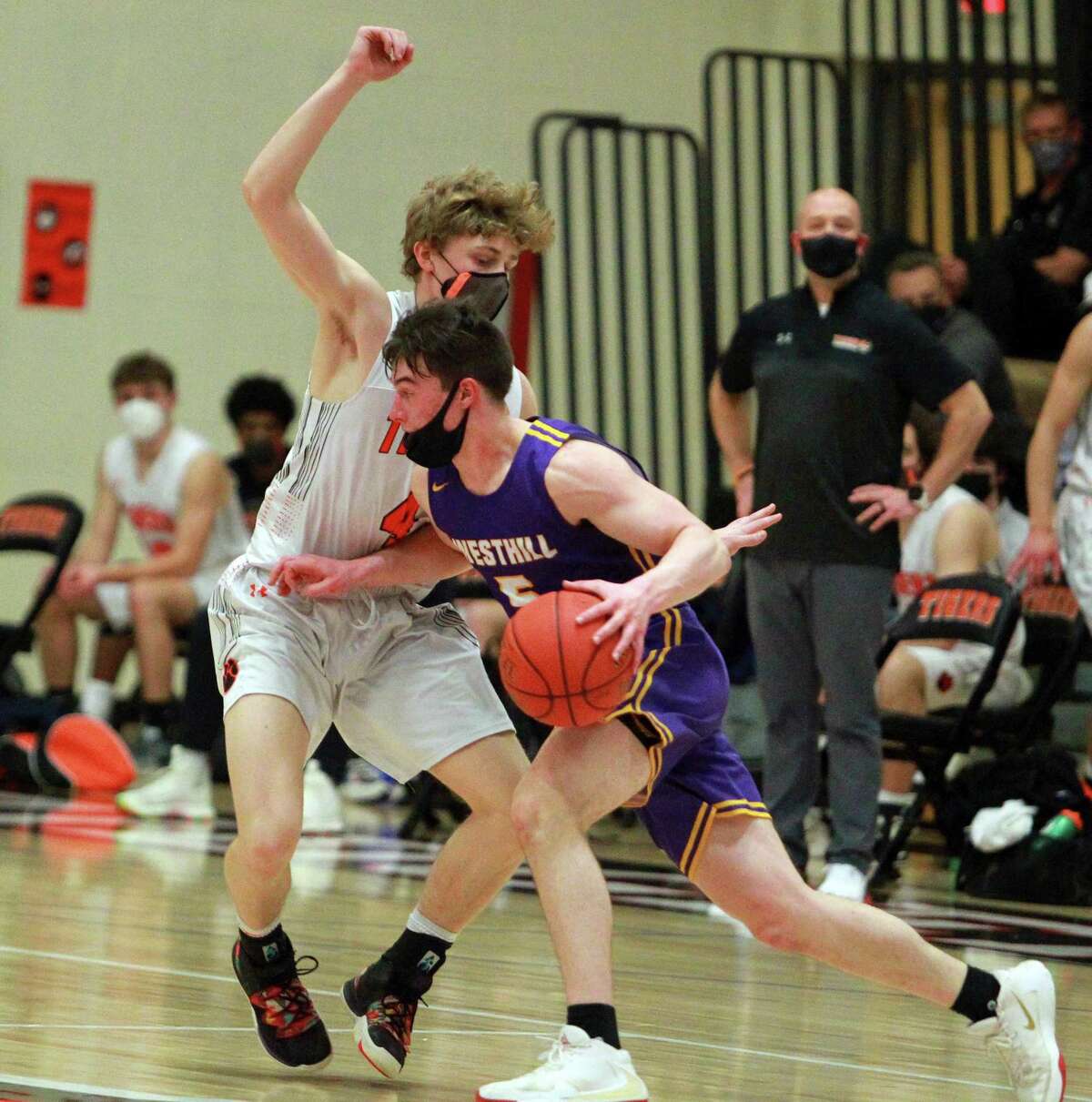 Westhill's Benjamin Pennella (5) breaks past Ridgefield's Alister Walsh (4) during FCIAC championship boys basketball game action in Ridgefield, Conn., on Friday March 27, 2021.