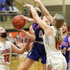 Carlinville's Jill Stayton (4) puts up a shot between Staunton defenders Haris Legendre and Savannah Billings (32) on Friday night in the championship game of the Macoupin County Tournament at The Pit in Gillespie.