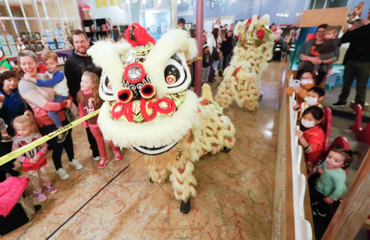 Members of the Houston Lion Kings perform a dragon dance in celebration of the Lunar New Year at The Woodlands Children's Museum, Saturday, Jan. 22, 2022, in The Woodlands.