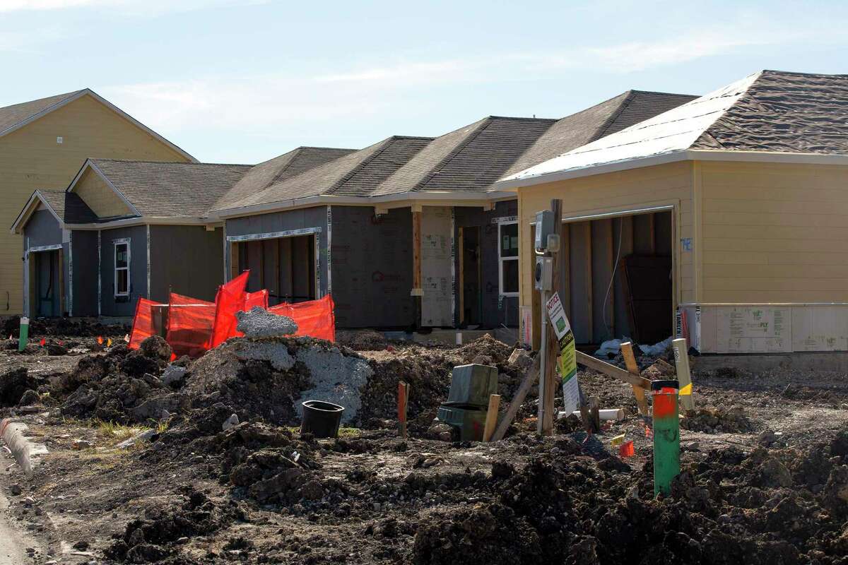 Crews work on homes under construction in Converse on January 14, 2022.