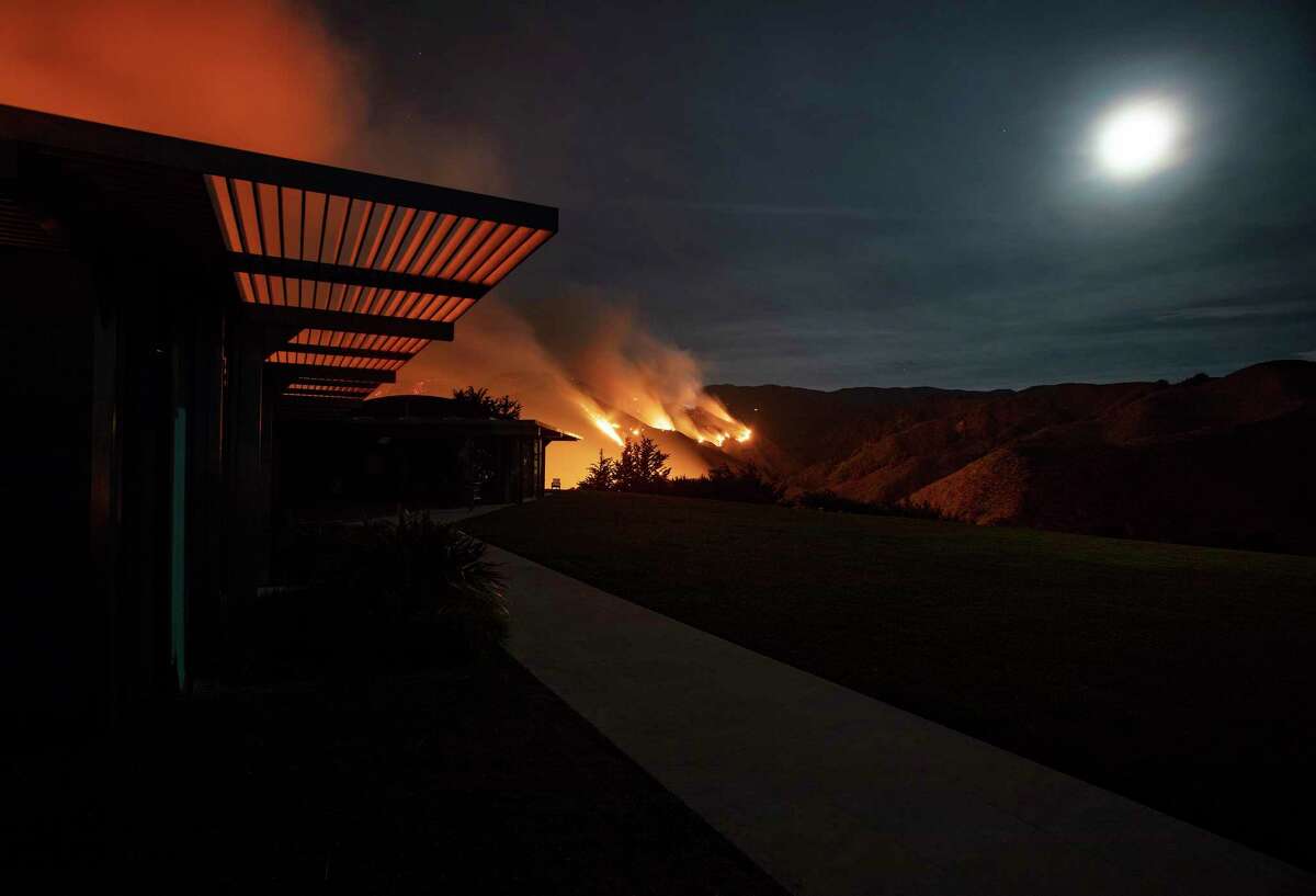 The Colorado Fire, burning along the Big Sur coast, is visible from a house above Rocky Creek Canyon.