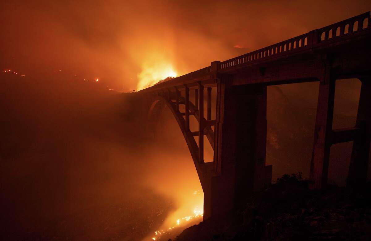 The Colorado Fire burns behind Rocky Creek Bridge near Big Sur, Calif. on the night of Friday Jan. 21, 2022.