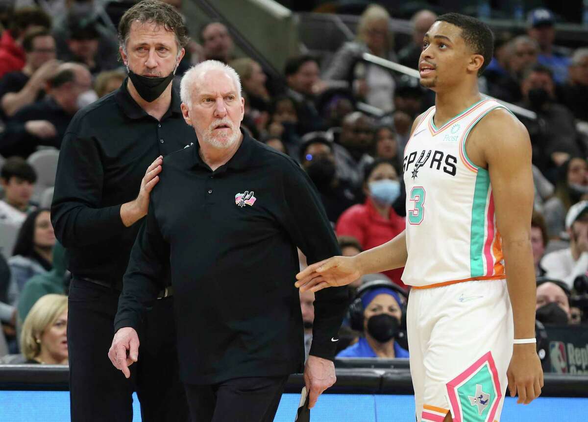 Spurs head coach Gregg Popovich (center) gets called for technical foul as assistant coach Matt Nielsen (left) and Keldon Johnson (03) try to calm him down during the second half against the Brooklyn Nets at the AT&T Center on Friday, Jan. 21, 2022. Nets defeated the Spurs, 117-102.