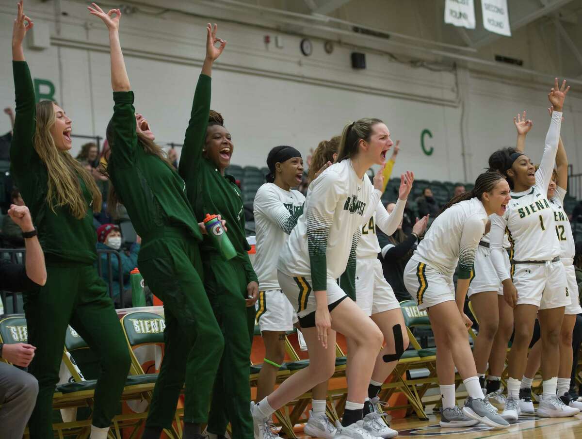 Siena women’s basketball players on the bench cheer for a three-point basket made by their teammate, Anja Knoflach (not shown) during a game on Saturday, Jan. 22, 2022, at Siena College in Loudonville, N.Y. (Jenn March, Special to the Times Union )