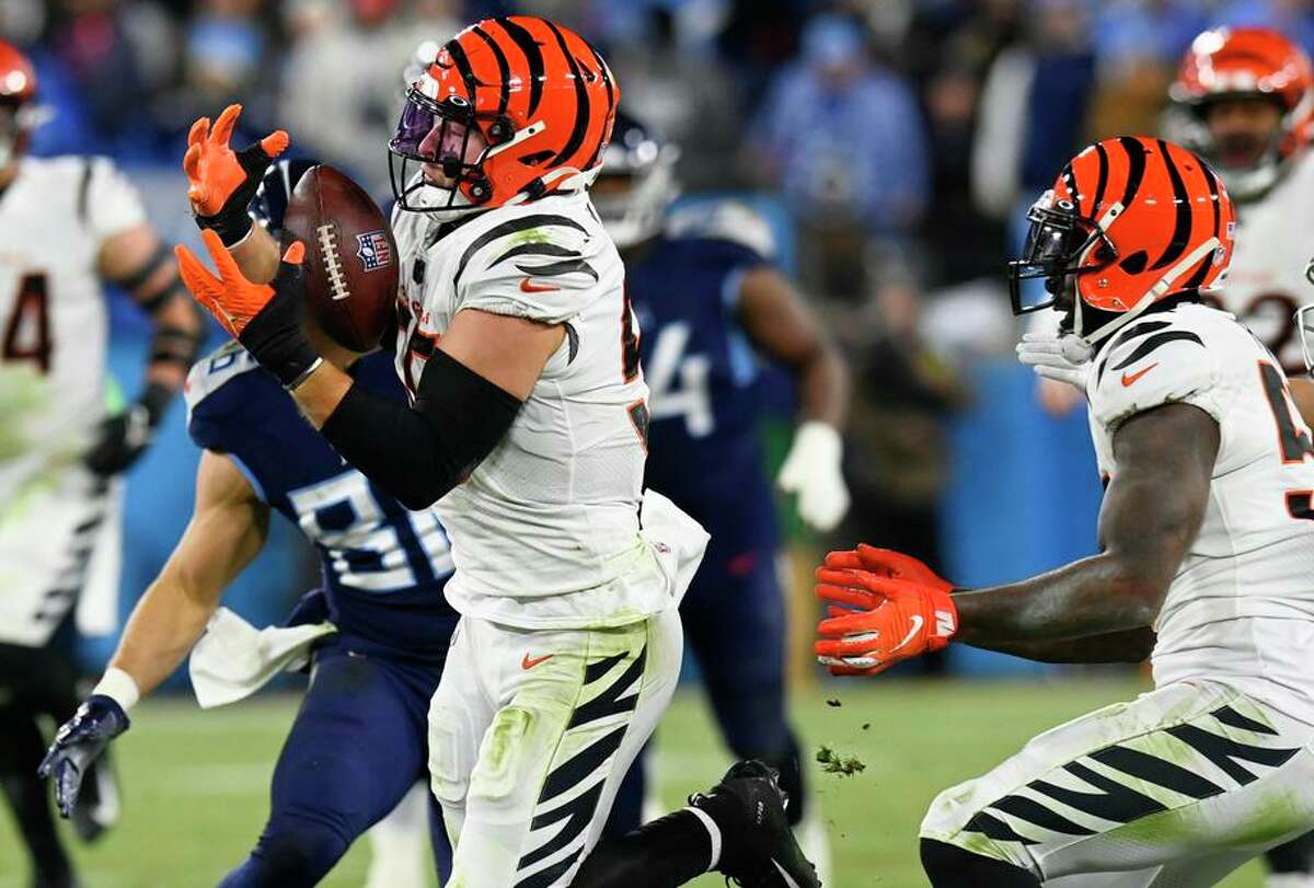 Bengals linebacker Logan Wilson secures one of three passes Cincinnati intercepted Saturday against the Titans.