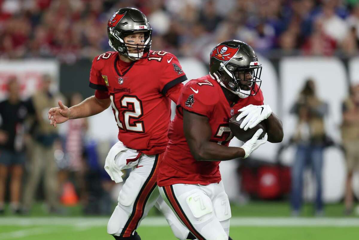 Buccaneers quarterback Tom Brady and running back Leonard Fournette, seen on Nov. 22 in a win over the New York Giants, may have to work behind an injury-ravaged offensive line.