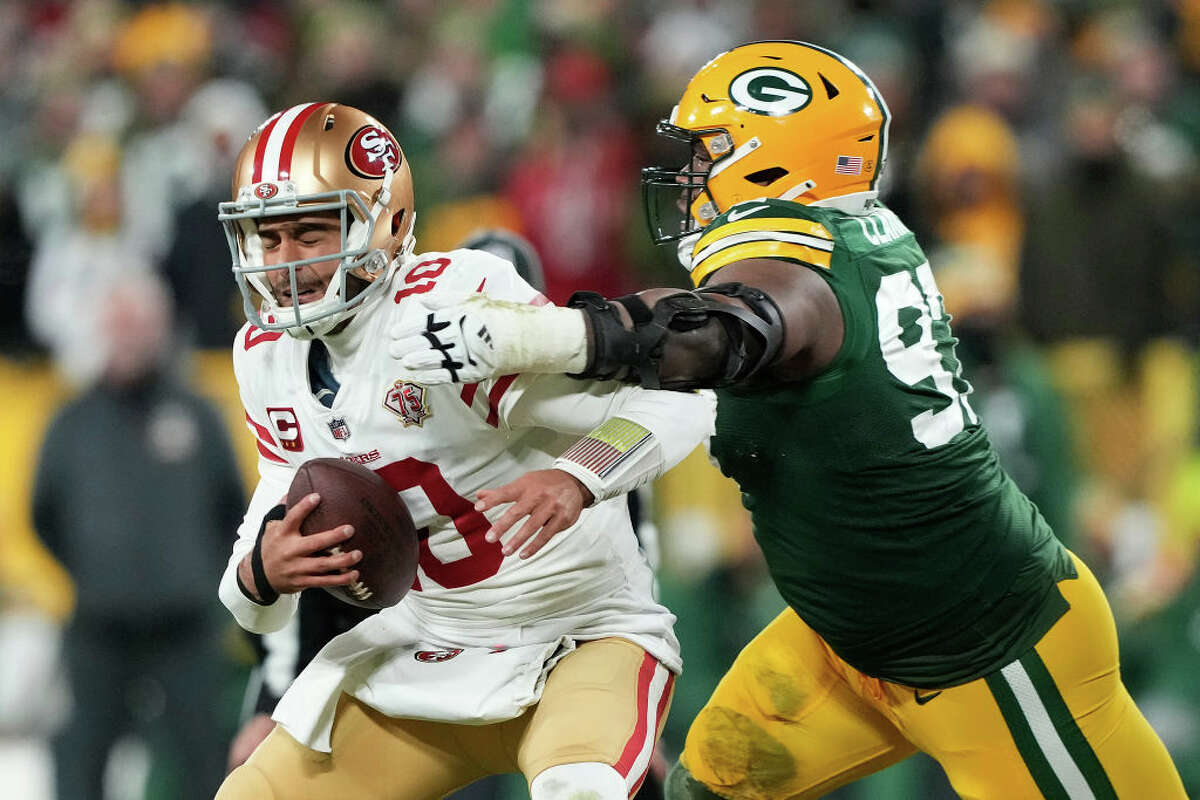 Quarterback Jimmy Garoppolo of the San Francisco 49ers is sacked by nose tackle Kenny Clark of the Green Bay Packers during the first half of the NFC divisional playoff game.