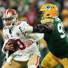 Quarterback Jimmy Garoppolo of the San Francisco 49ers is sacked by nose tackle Kenny Clark of the Green Bay Packers during the first half of the NFC Divisional Playoff game.