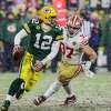 Green Bay Packers quarterback Aaron Rodgers (12) drops back to pass as snow falls as the San Francisco 49ers play the Green Bay Packers in the NFL Divisional Round playoff game at Lambeau Field in Green Bay, Wis., on Saturday, January 22, 2022.