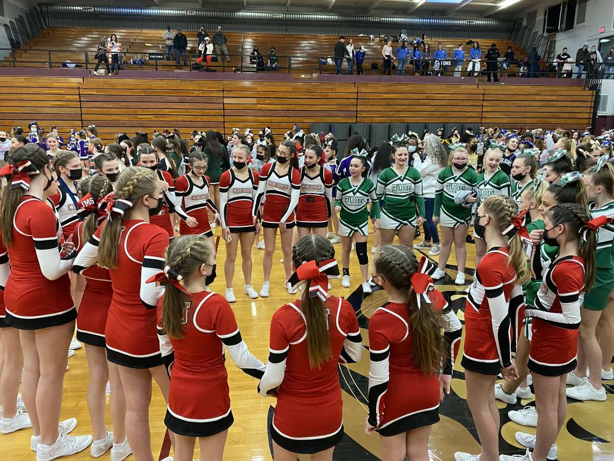 Jacksonville Middle School and Our Saviour School cheerleaders gather in a circle before awards were handed out Saturday.