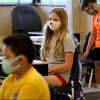 Students in fifth grade wear masks as they wait for their teacher in a classroom at Oak Terrace Elementary School in Highwood.