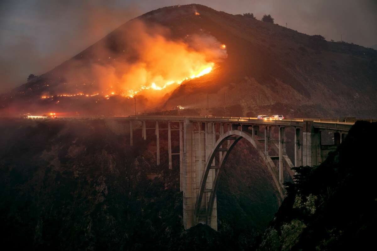 The Colorado Fire burns down toward the Bixby Bridge in Big Sur, California, early Saturday morning, Jan. 22, 2022.