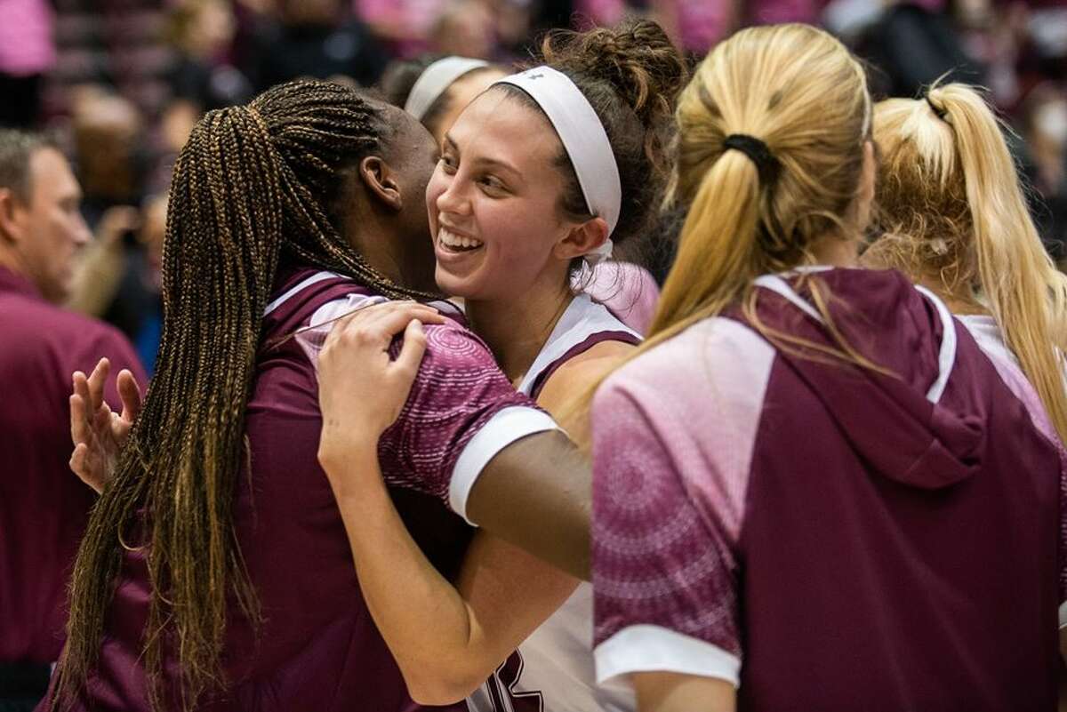 SIU senior guard Makenzie Silvey is congratulated after breaking the program's scoring record on Saturday.