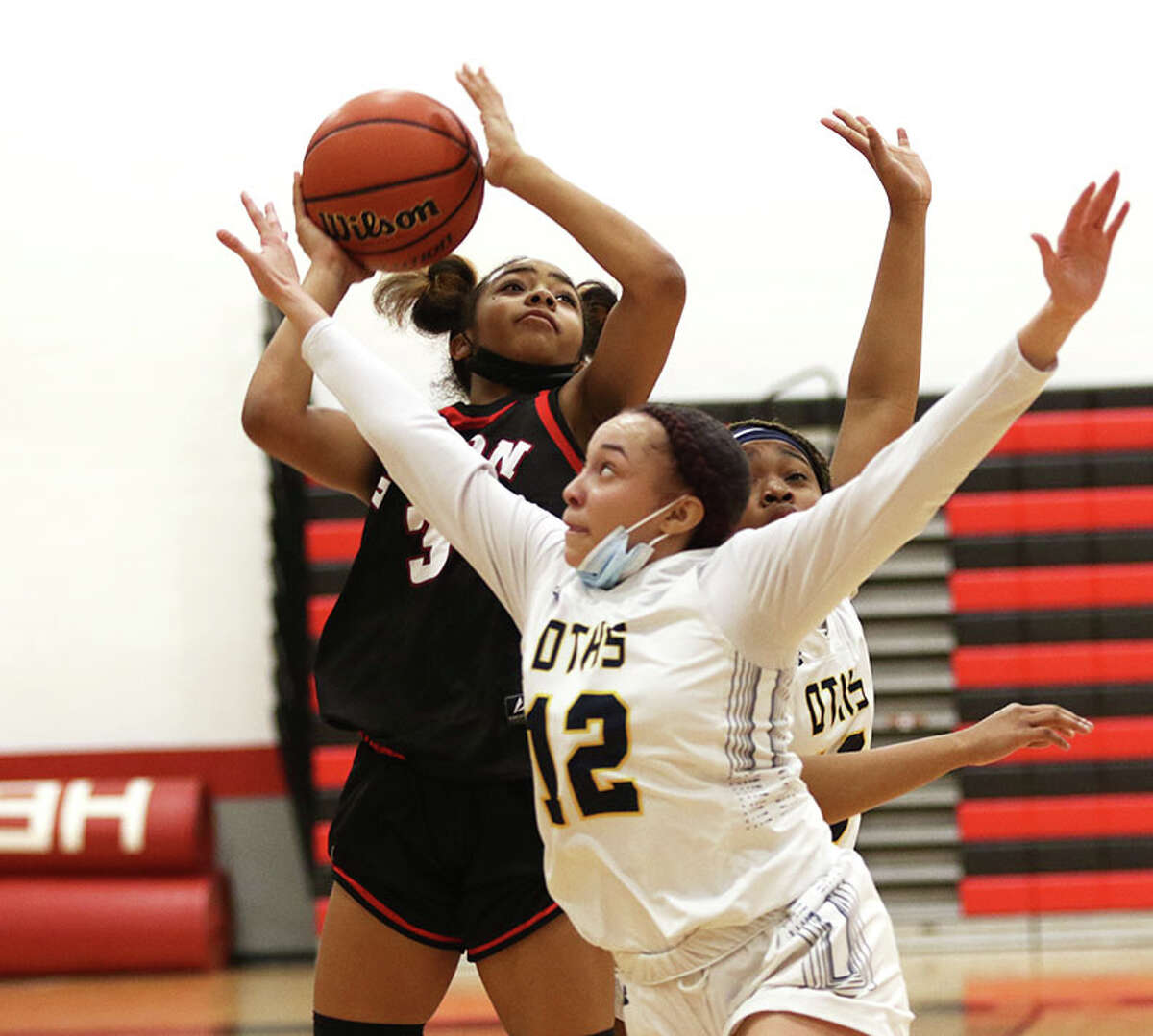 Alton's Kiyoko Proctor shoots over O'Fallon's Laylah Jackson (12) in the second of Saturday's third-place game at the Highland ApexNetwork Tournament.
