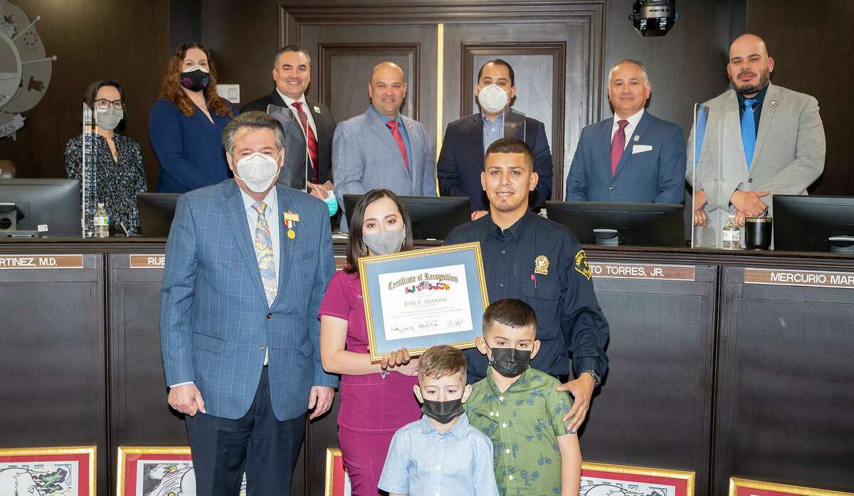 Mayor Pete Saenz and the rest of City Council gather for a photo with Jose E. Aranda and his family, Kristina Garza, Timothy Aranda and Jose Aranda, Tuesday, Jan. 18, 2022, at City Hall as Aranda is recognized for saving 45 cats from a fire at the Laredo Animal Care Services facility.