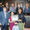 Mayor Pete Saenz and the rest of City Council gather for a photo with Jose E. Aranda and his family, Kristina Garza, Timothy Aranda and Jose Aranda, Tuesday, Jan. 18, 2022, at City Hall as Aranda is recognized for saving 45 cats from a fire at the Laredo Animal Care Services facility.