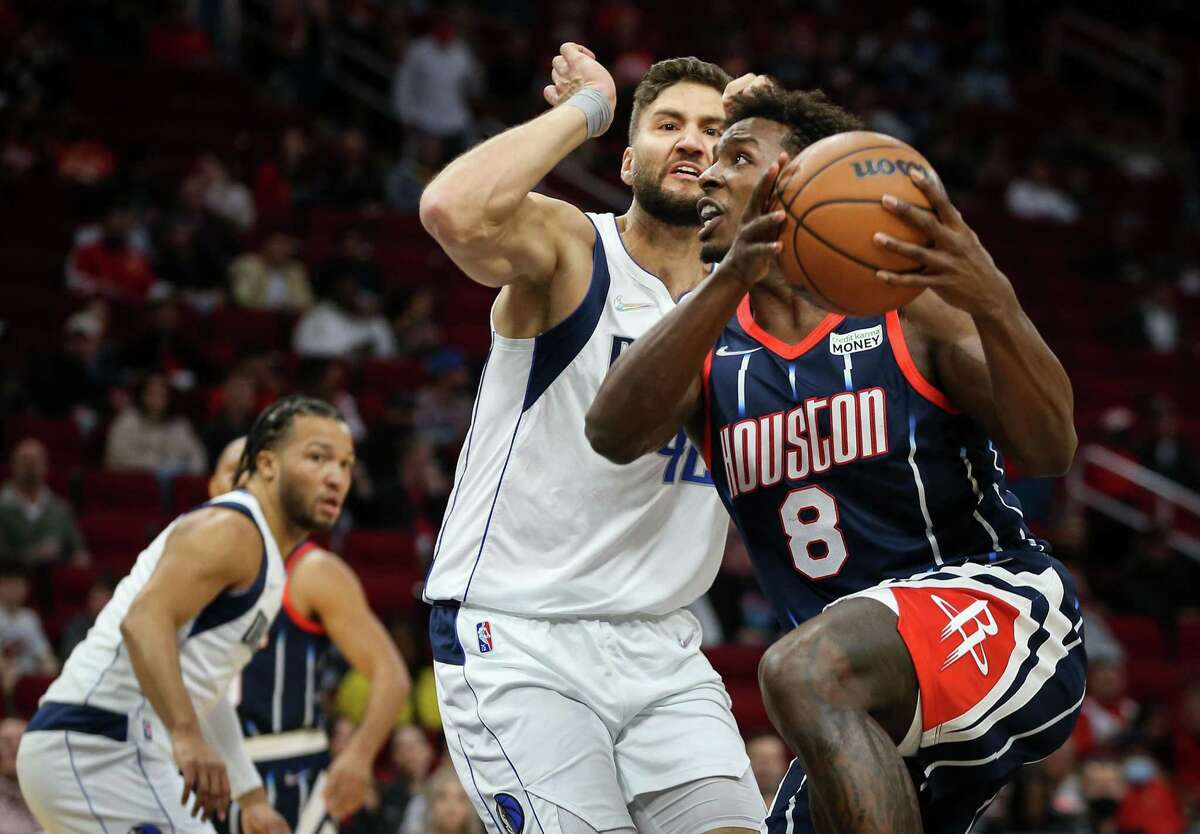 Houston Rockets forward Jae'Sean Tate (8) drives to the basket while Dallas Mavericks forward Maxi Kleber (42) defends during the first quarter of an NBA game Friday, Jan. 7, 2022, at the Toyota Center in Houston.