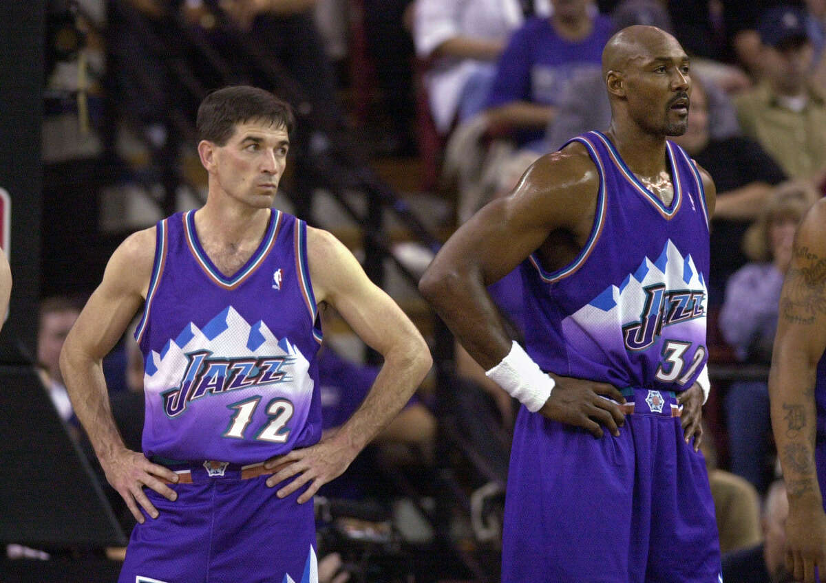 Utah Jazz's John Stockton, left, and Karl Malone watch as the Sacramento Kings walk onto the court following a time-out during the third quarter of Game 5 of the Western Conference first-round playoff series, Wednesday, April 30, 2003, in Sacramento, Calif. The Kings won 111-91, winning the series 4-1.