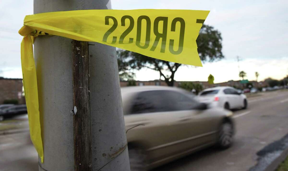 Police tape remains on a lamp post where Harris County Precinct 5 deputy, Charles Galloway was killed on Sunday, Jan. 23, 2022 in Houston .