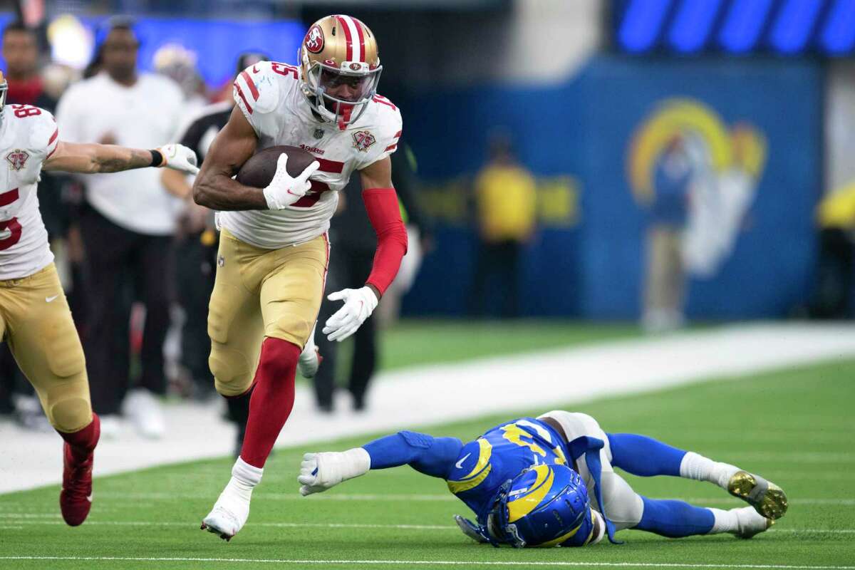 San Francisco 49ers wide receiver Jauan Jennings (15) runs with the ball past Los Angeles Rams safety Nick Scott (33) during an NFL football game Sunday, Jan. 9, 2022, in Inglewood, Calif. (AP Photo/Kyusung Gong)