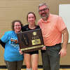 Edwardsville graduate Paul Vieth with his wife and daughter Madison, a senior on the EHS volleyball team, with the super-sectional championship plaque last fall. The Tigers went on to place fourth in the Class 4A state tournament.