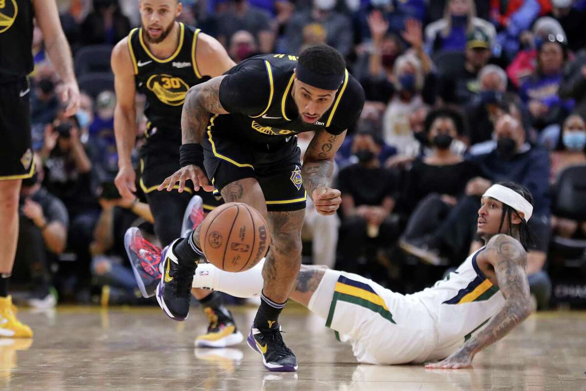 Golden State Warriors' Gary Payton II steals the ball from Utah Jazz' Jordan Clarkson in 3rd quarter during NBA game in San Francisco, Calif., on Sunday, January 23, 2022.