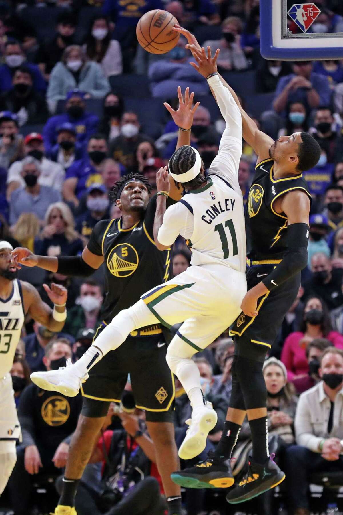 Golden State Warriors' Otto Porter, Jr. blocks a shot by Utah Jazz' Mike Conley late in 4th quarter of Warriors' 94-92 win in NBA game in San Francisco, Calif., on Sunday, January 23, 2022.
