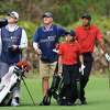 ORLANDO, FLORIDA - DECEMBER 19: Tiger Woods, Charlie Woods and their caddies Joe LaCava and Joe LaCava Jr. look on from the first hole during the final round of the PNC Championship at the Ritz Carlton Golf Club Grande Lakes on December 19, 2021 in Orlando, Florida. (Photo by Sam Greenwood/Getty Images)