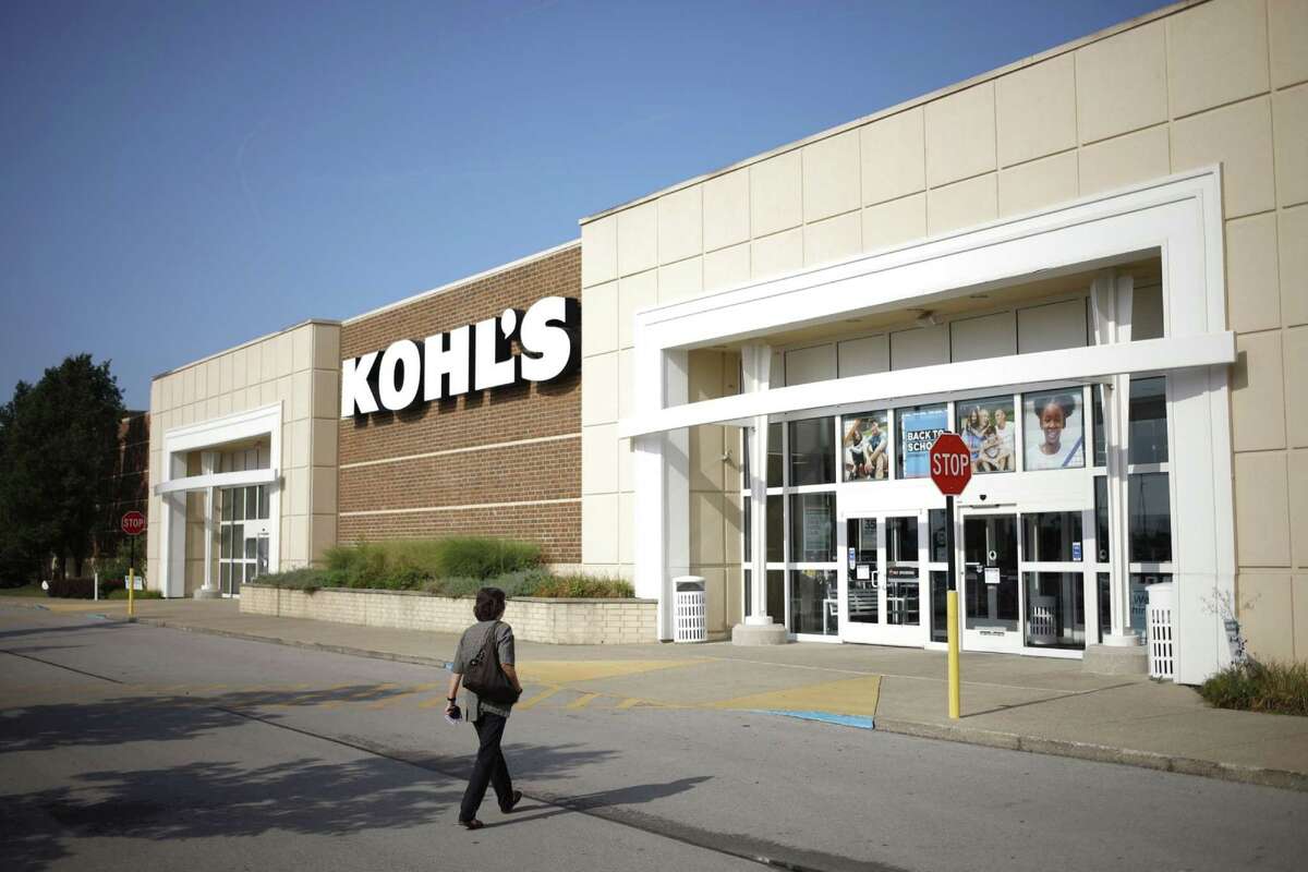 An employee walks towards the entrance of a Kohl's department store in Lexington, Ky., on Aug. 11, 2021.