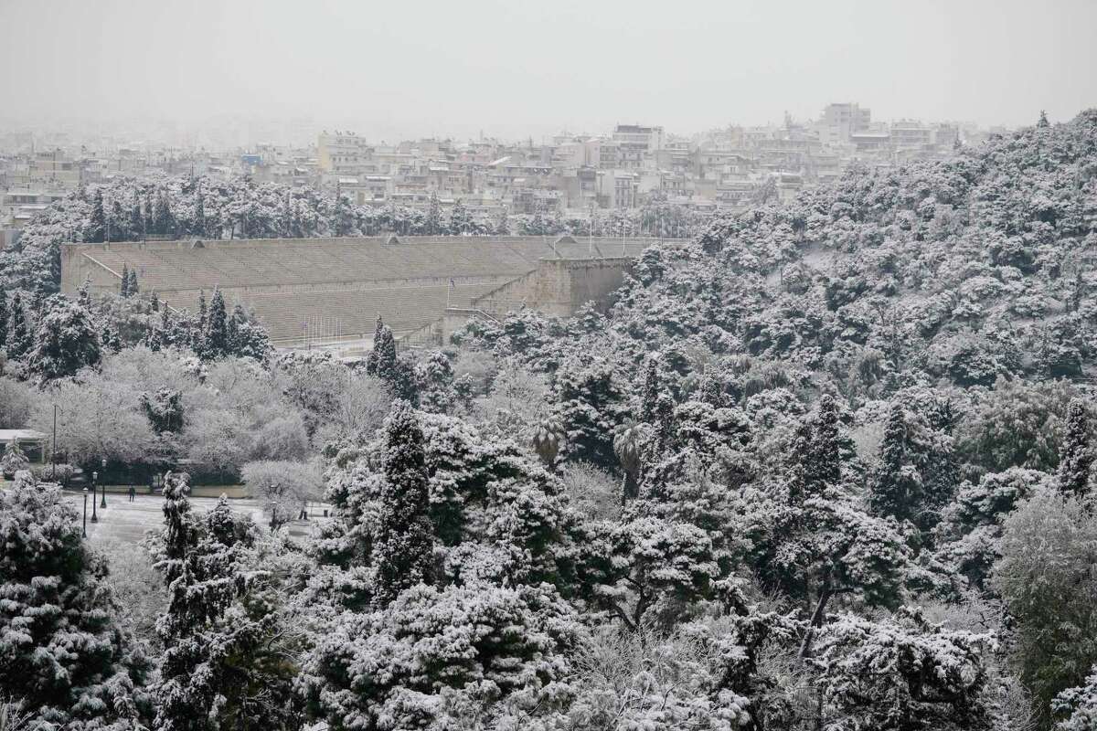 The Panathenaic Stadium, where the first modern Olympics were held in 1896, is covered with snow during a snowfall, in Athens, on Monday, Jan. 24, 2022.The wave of bad weather hitting Greece is forecast to continue through Tuesday, and has seen snow falling even on some islands. Authorities have warned the public to avoid all but essential outdoor movement, and several major roads and highways are passable only with snow chains.