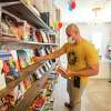 Phoenix Bookstore co-owner Jose R. Cantu arranges books as customers shop Saturday, April 24, 2021, at the Phoenix Bookstore during National Independent Bookstore Day.