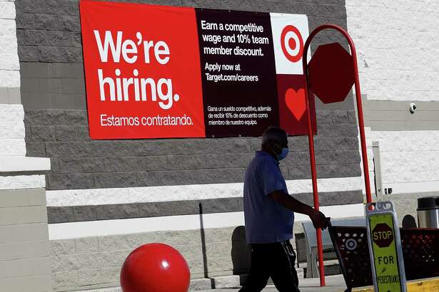 A We're hiring sign hangs on the wall of a Target store on December 03, 2021 in Miami, Florida. The Labor Department announced that payrolls increased by just 210,000 for November, which is below what economists expected, though the unemployment rate fell to 4.2% from 4.6%.
