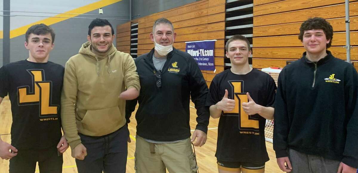 Law wrestling coach Matt Schoonmaker is flanked by senior Colin Meyers, Law alum Nick Newell, senior Dylan Benedetti and senior Luke Iaffaldano. Schoonmaker is 12th on active coach all-time win list. Law moved into 16th all-time in wins with its 600th.