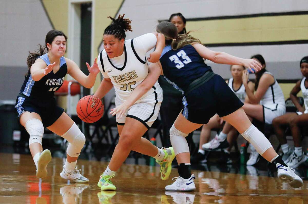 Conroe guard Isabella Stafford (32) splits Kingwood guards Kylie Nichols (11) and Devin Durkan (33) during a game at the annual Lady Tiger Classic, Thursday, Nov. 11, 2021, in Conroe.
