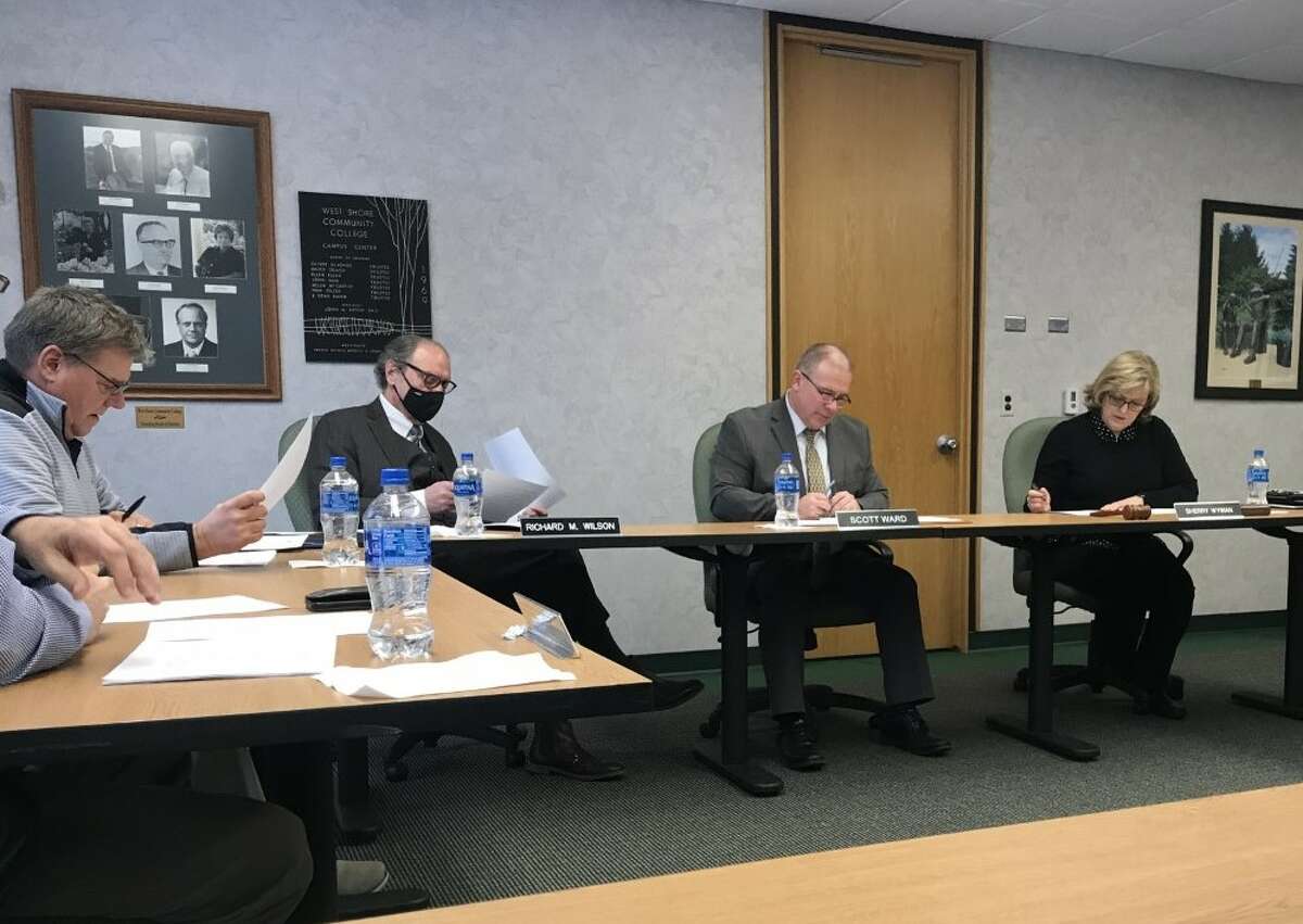 Thomas Kaminski, West Shore Community College board trustee (left); Richard Wilson, vice chair; Scott Ward, president; and Sherry Wyman, chair, discuss plans for remodeling the second floor of the Schoenherr Campus Center during a board meeting on Jan. 17.