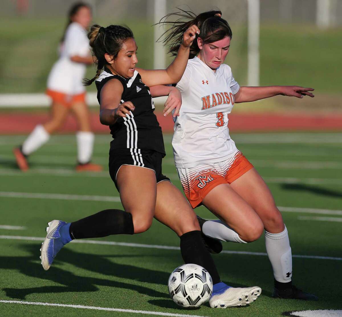 Steele’s Zoey Palma (21) looks to pass against Madison’s Jaycie Bass (03) during their Class 6A first-round girls soccer playoff game at Steele High School on Friday, March 26, 2021.