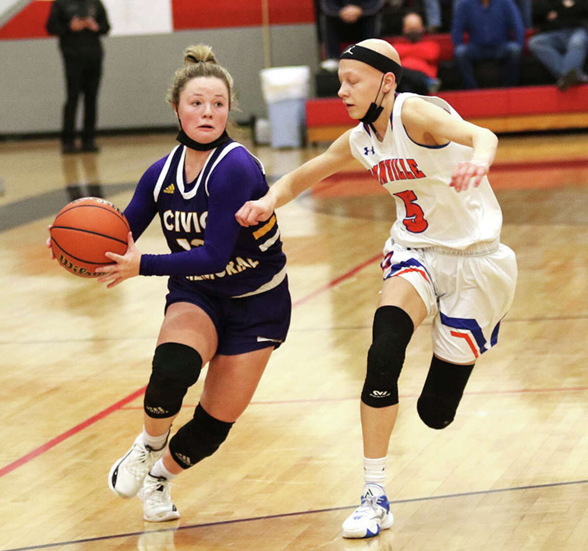 CM's Aubree Wallace (left) takes the ball to the basket against Okawville's Alayna Krase on Saturday at the Highland Tourney. Wallace was the tourney's MVP, while Kraus was a first-team all-tournament pick.