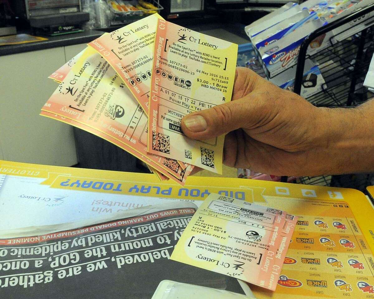 A hand holds a collection of Connecticut Lottery tickets in this file photo. 