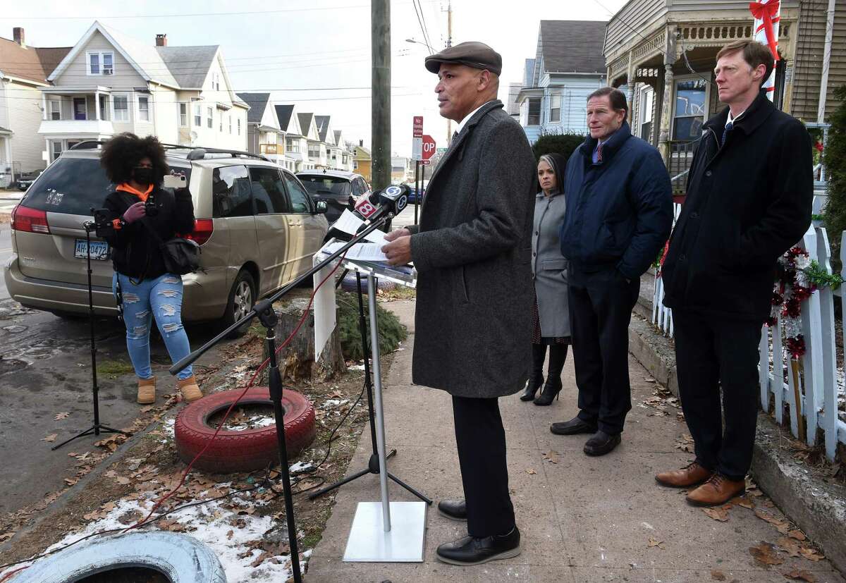 New Haven Environmental Health Program Director Rafael Ramos, center, speaks about the HUD funding for the city’s Healthy Homes Program at a press conference on Grafton Street in New Haven on Jan. 24, 2022.