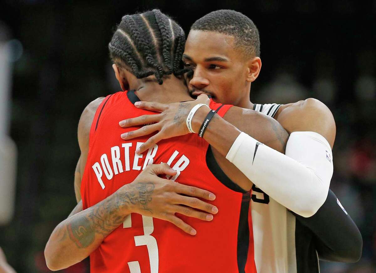 Kevin Porter Jr. and Dejounte Murray share a hug before a recent Rockets-Spurs game in San Antonio. The two players grew up in the same area of Seattle and have many shared memories of escaping a tough environment.