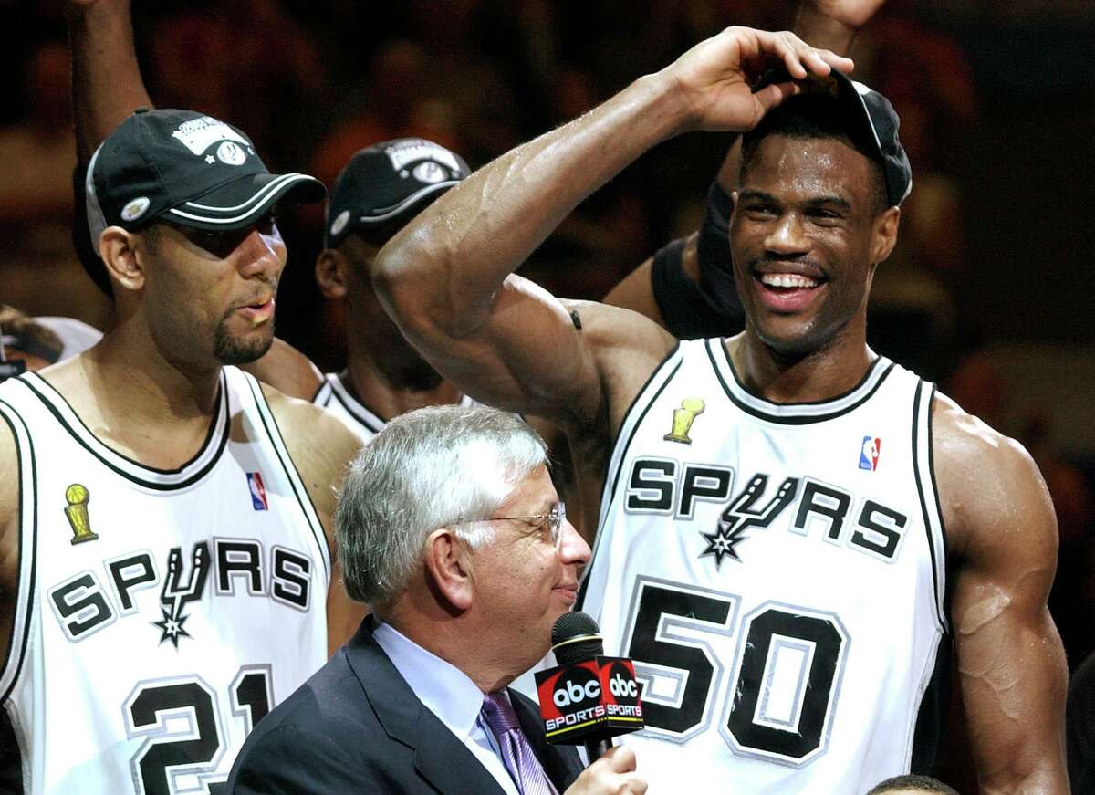 San Antonio Spurs player Tim Duncan, center, celebrates with teammates  Steve Smith, left, and Kevin Willis after the Spurs beat the New Jersey  Nets, 88-77, to win the NBA Championship in San