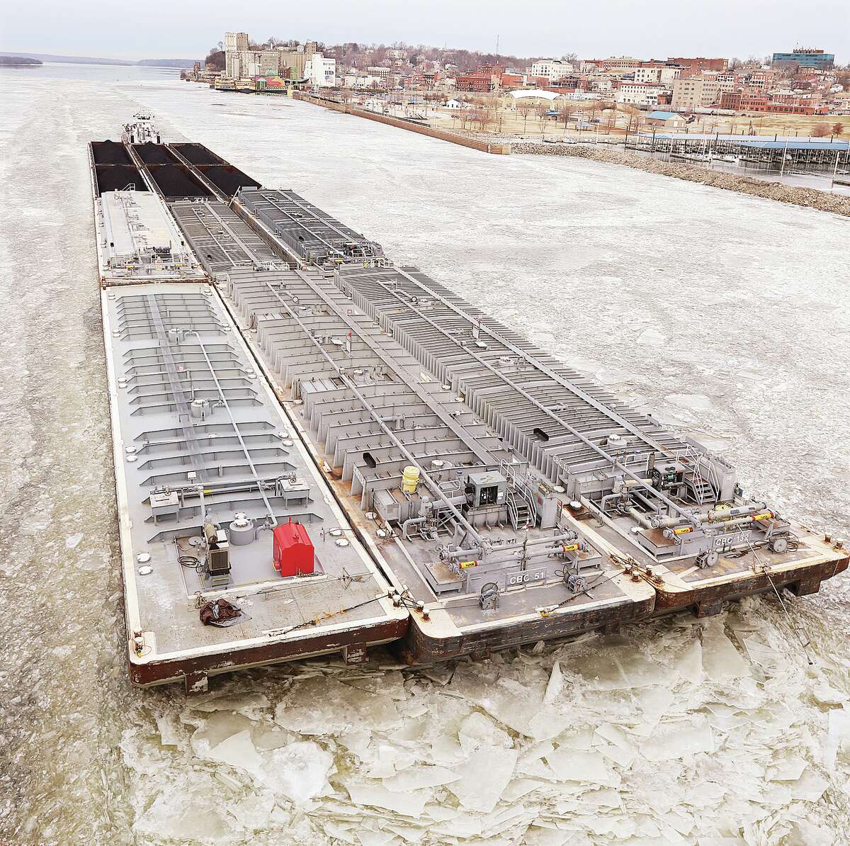 John Badman|The Telegraph A towboat and barges carrying liquified petroleum gas and coal break through the Mississippi River ice near Alton Monday morning just before crossing under the Clark Bridge on its way downstream to the Melvin Price Locks and Dam 26. Cargo on the river changes with the seasons. The U.S. Energy Information Administration estimates 85 percent of the electricity generated in the United States this year will come from coal-fired power plants.