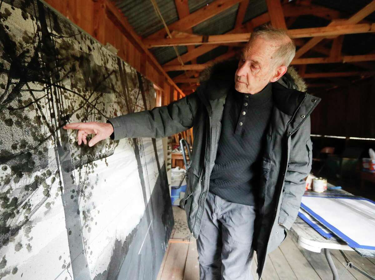 Martin Amorous talks about the evolution of his splatter painting technique at his home studio, Friday, Jan. 21, 2022, in Willis.