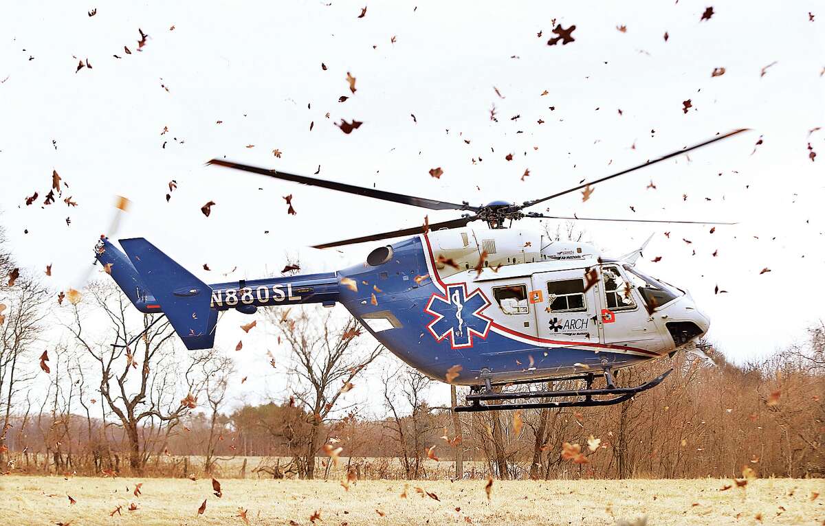 John Badman|The Telegraph Hundreds of leaves were blown through in the air Monday as an ARCH helicopter ambulance landed in the farm field just off Woodburn Road for an accident victim.