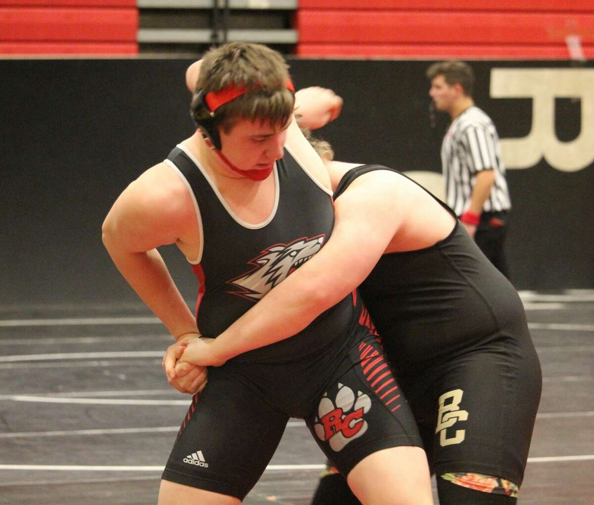 Reed City's Wyatt Spalo (left) battles against an opponent in home wrestling action on Saturday.