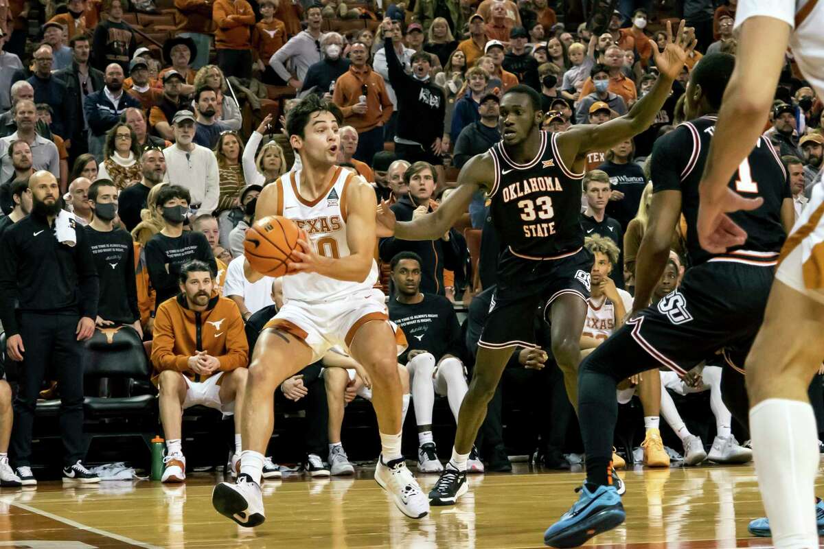 Brock Cunningham, left, won’t set any scoring records, but UT can count on him to rebound, draw charges, dive for loose balls and energize teammates.