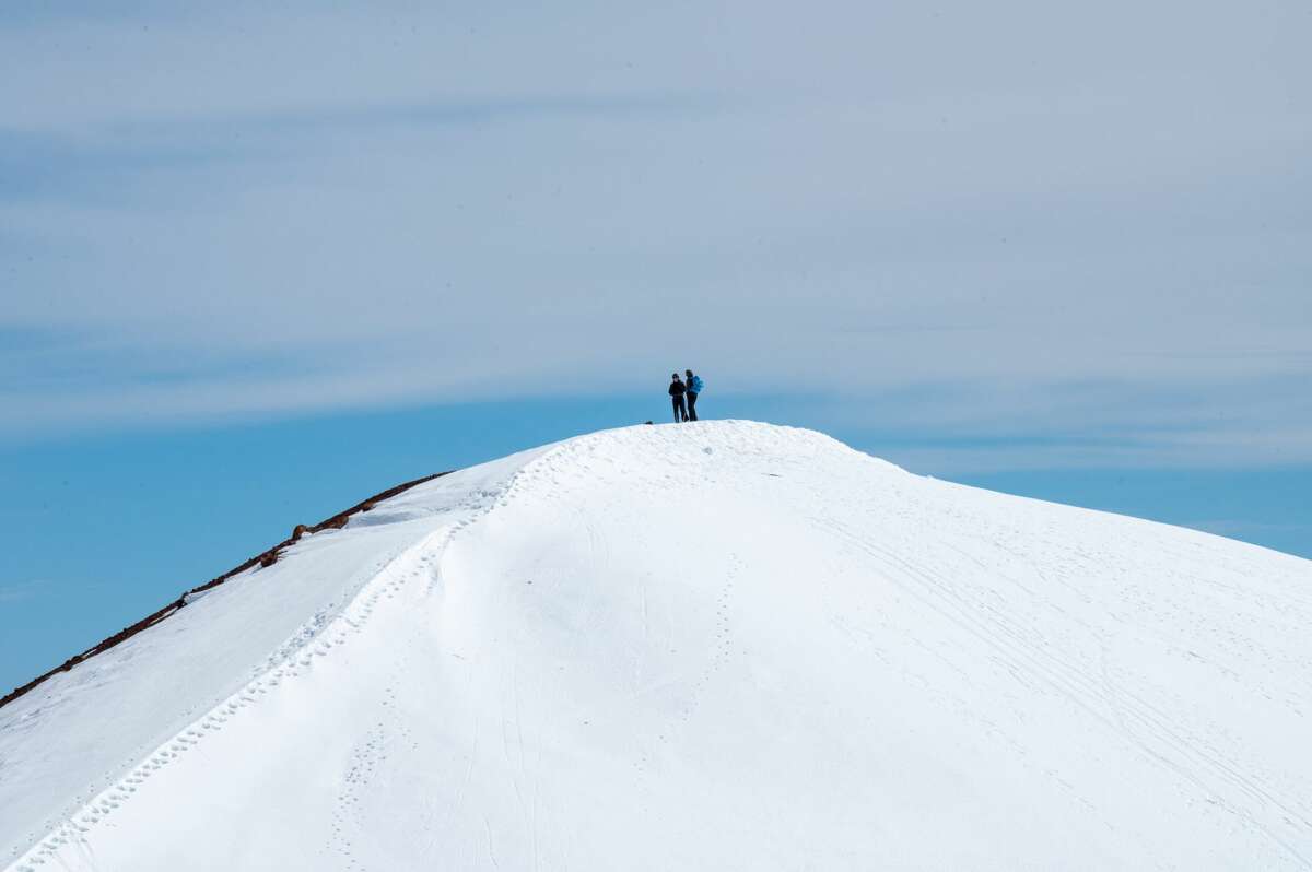 Victor Vescovo and Cliff Kapono reach the summit of Maunakea Volcano.