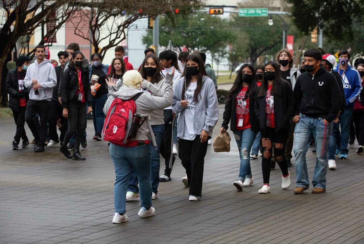 Majority-masked campus tour groups walk on the University of Houston campus Monday, Jan. 24, 2022, in Houston.